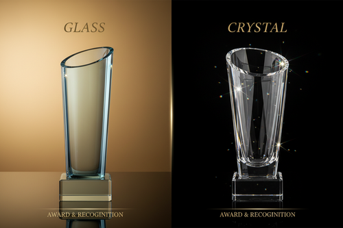 A premium crystal trophy and glass award displayed on a desk for corporate employee recognition awards by Meru Trophy.