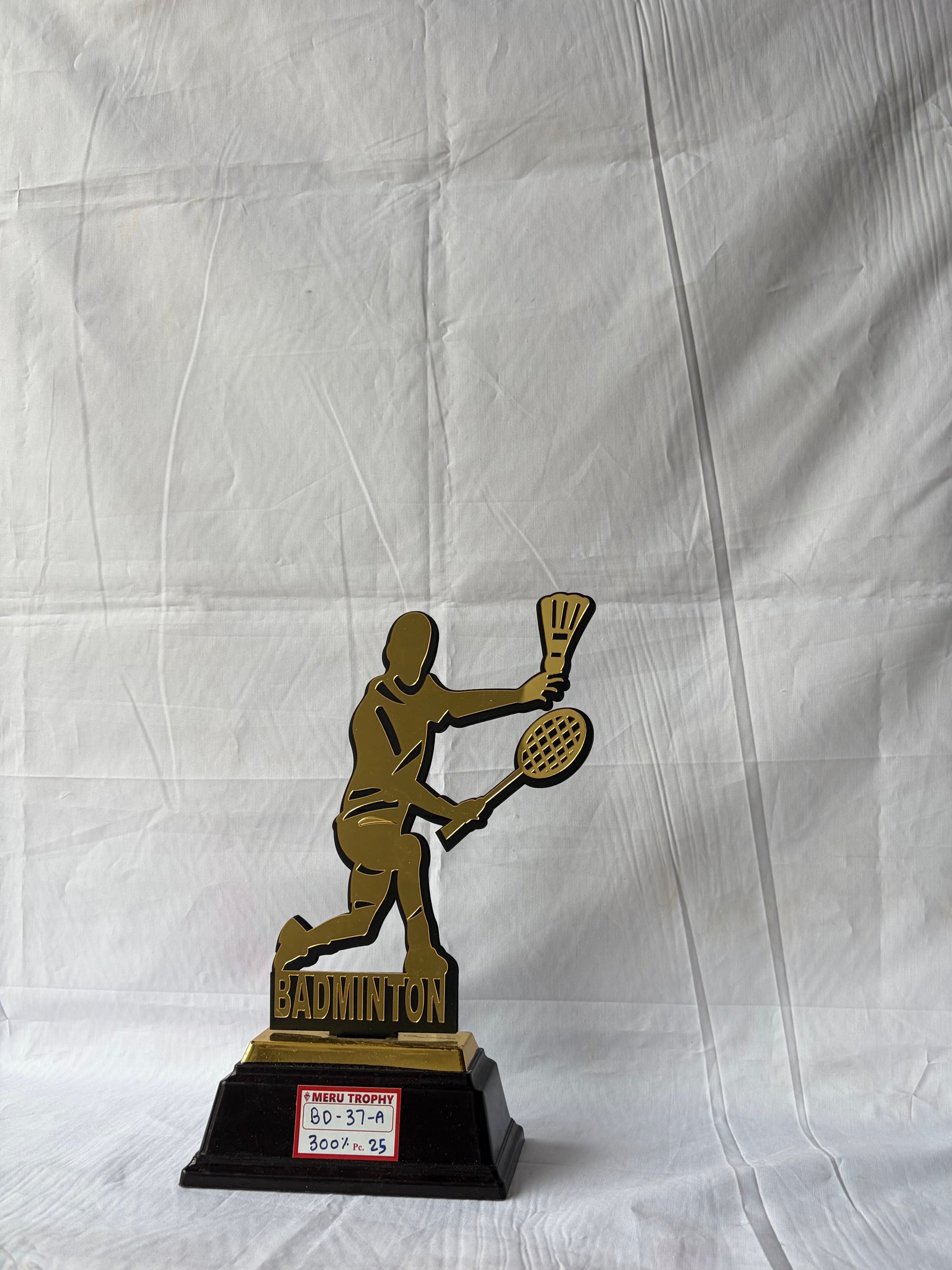 Gold badminton player silhouette on black base BD 37 A sports trophies for tournament winners by Meru Trophy.