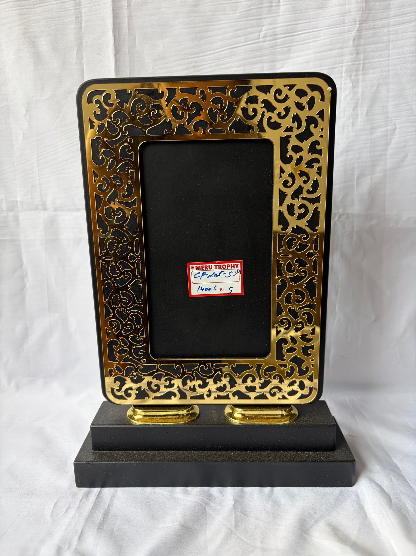 CP 205 decorative plaques featuring a black panel with an intricate gold filigree border on a tiered black base