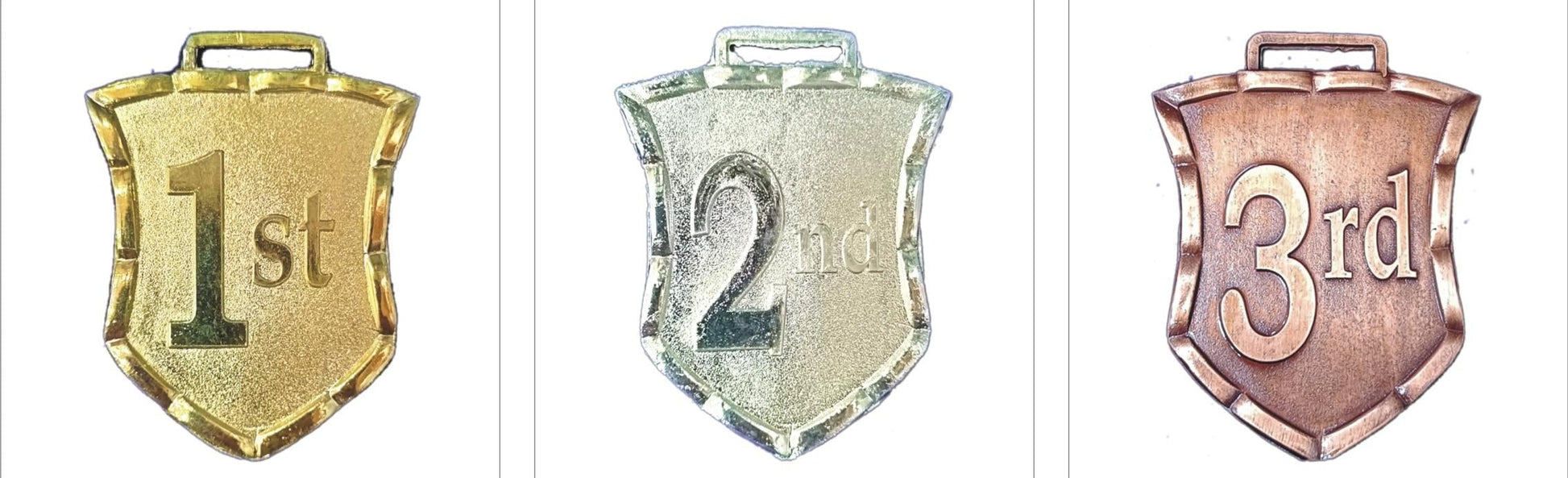 Gold; silver; and bronze shield medals for awards and recognition.